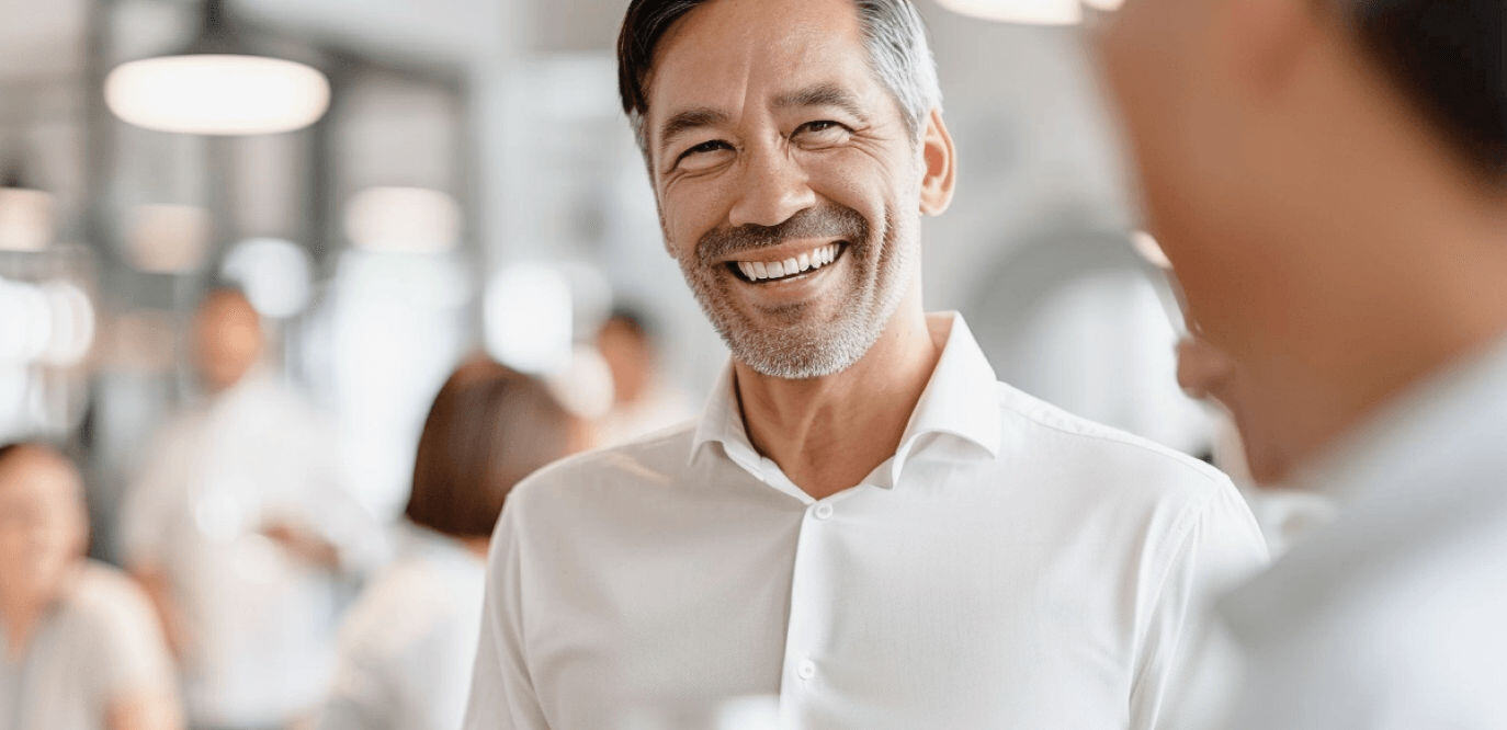 Male colleague smiling at another colleague in an office