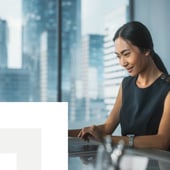 Businesswoman working on a computer smiling