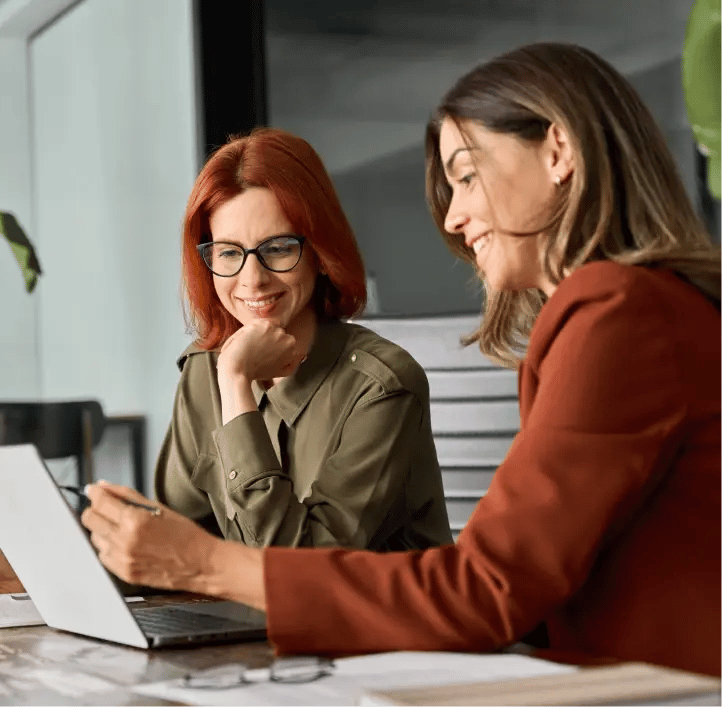 two business women looking at a laptop